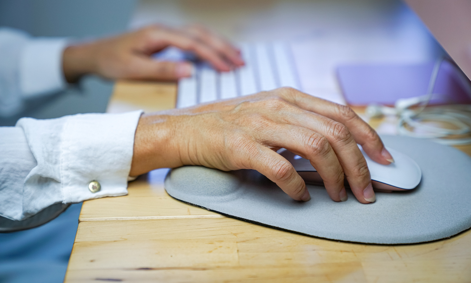 Woman's Fingers Clicking on Mouse, Resting Her Wrist on Wrist Re